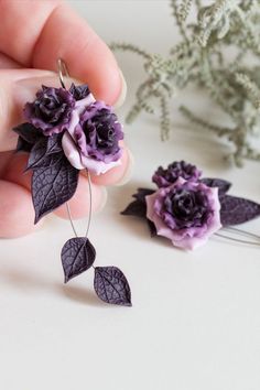 Polymer clay artisan earrings with deep purple miniature rose flowers and dark plum leaves. Purple Rose Design Jewelry As Gift, Purple Dangle Polymer Clay Jewelry, Purple Flower-shaped Handmade Jewelry, Purple Flower-shaped Jewelry With Handmade Flowers, Handmade Purple Flower-shaped Jewelry, Elegant Purple Jewelry With 3d Flowers, Purple Flower Jewelry With Handmade Details, Purple Flower Jewelry With Handmade Flowers, Elegant Purple Polymer Clay Earrings