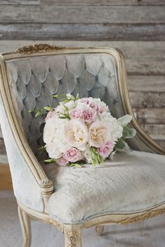 a bouquet of flowers sitting on top of a chair