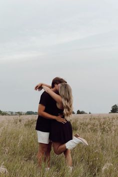 two people in a field hugging each other