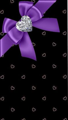 a purple bow with a diamond in the center and hearts around it on a black background