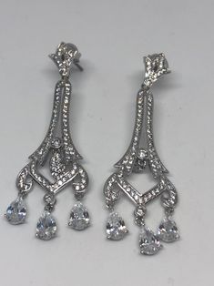 Vintage chandelier earrings silver diamond look Austrian crystal Handmade vintage silver rhodium over white bronze Crystal earrings These really look like white gold with diamond accents About 2.25 long All jewelry is shipped in a nice gift box. Check out our over a THOUSAND great reviews Silver Diamond Pierced Earrings For Evening, Glamorous Formal Chandelier Earrings With Diamond Accents, Dazzling Silver Chandelier Earrings For Evening, Silver Cubic Zirconia Chandelier Earrings For Party, Silver Elegant Chandelier Earrings As Gift, Chandelier Drop Earrings With Diamond Accents For Anniversary, Elegant Silver Chandelier Earrings As Gift, Elegant Silver Chandelier Earrings For Gift, Silver Sparkling Chandelier Earrings For Formal Occasions