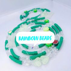 green and white beaded necklaces with the words rainbow beads on it's side