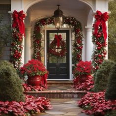 a front porch decorated for christmas with poinsettis and wreaths