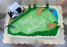 a birthday cake with a golf theme on the side and a truck in the background