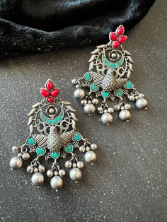 Handcrafted in Brass and stones with antique polish. Premium Quality Pick them up and make a stunning statement. The weight of the earrings is 38 g per pair. Vintage Festive Earrings With Intricate Design, Elegant Antique Finish Earrings For Festive Occasions, Antique Chandbali Earrings As Gift, Antique Chandbali Earrings For Gift, Antique Drop Earrings For Festive Occasions, Vintage Jhumkas For Festive Occasions, Vintage Jhumkas For Festive Gift, Festive Antique Drop Earrings, Vintage Danglers With Intricate Design For Festive Occasions