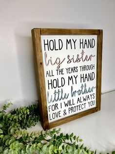 a wooden sign that says hold my hand, it's sister all the years through hold my hand little brother for i will always love & protect you