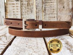 Indulge in timeless style with our meticulously crafted handmade brown narrow leather belt. Each piece is expertly finished with a vintage touch, exuding character and charm. The sleek 2cm width and elegant silver buckle add sophistication to any outfit, making it a versatile accessory for both men and women. Elevate your wardrobe with this artisanal masterpiece, designed to withstand the test of time and garner admiration wherever you go. Features: Made of high-quality genuine leather 2 cm width Unisex Available in a variety of colors Benefits: Stylish and versatile Durable and long-lasting Comfortable to wear Perfect for any occasion Guarantee: We are so confident that you will love this belt that we offer a 100% satisfaction guarantee. If you are not happy with your purchase for any rea Vintage Bridle Leather Belt For Everyday Use, Formal Brown Belts And Suspenders With Brass Buckle, Adjustable Brown Bridle Leather Belt Buckles, Brown Bridle Leather Belts And Suspenders For Everyday, Brown Leather Belts And Suspenders For Gift, Brown Leather Belt And Suspenders For Gift, Brown Leather Belts And Suspenders As Gifts, Brown Leather Belt And Suspenders As Gift, Everyday Brown Belt Buckles With Belt Included