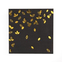 black and gold napkin with leaves on it