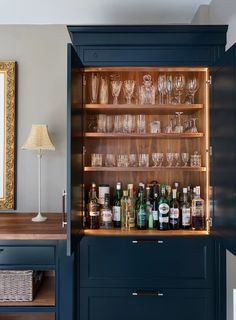 a cabinet filled with lots of bottles and glasses