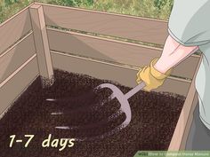 a person digging dirt in a wooden box