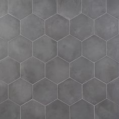 a gray tiled wall with hexagonal tiles in the shape of hexagons