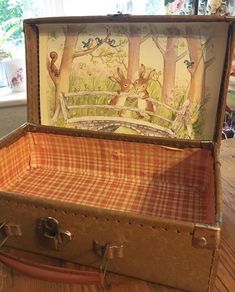 an open suitcase sitting on top of a wooden table