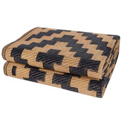 two pieces of woven material with black and tan designs on them, one is folded over the other