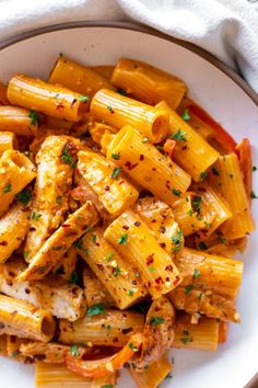 a white plate topped with pasta and chicken