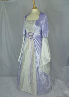 This dress will be made to your measurements.Please send your bust, waist and hip measurements and please measure from the top of your shoulder to the floor with shoes on. It will be made with lovely lilac or ivory crushed velvet and with a stunning ivory embroidered silk with silver detailing. The sleeves are part velvet and taffeta. It has a corset style front and back with lacing so you can adjust the dress to fit your body shape.Combined shipping on multiple items.If you purchase express shi Fitted Ball Gown With Ruched Bodice, Fitted Princess Ball Gown For Bridesmaid, Fitted Floor-length Purple Wedding Dress, Princess Style Fitted Bridesmaid Dress For Wedding, Fitted Floor-length Ball Gown With Ruched Bodice, Fitted Ball Gown With Corset Back For Banquet, Floor-length Corset Dress With Ruched Bodice For Weddings, Princess Style Fitted Ball Gown For Banquet, Princess Style Fitted Ball Gown Evening Dress