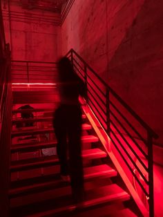 a person walking up some stairs with red lights