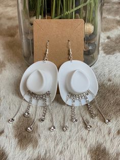 "These white rhinestone mini cowboy hat earrings are adorable! Perfect for girls night, bachelorette parties, concerts, Nashville trips, or ANY occasion. The mini cowboy hat is made of a lightweight, durable plastic. The rhinestone fringe is silver with super sparkly crystals. The rhinestone fringe is attached with industrial strength adhesive. Not hot glued. The silver plated ear wires are nickel & lead free and hypoallergenic. Rubber stoppers included. Each earring measures approximately 4.5\" Adjustable Western Style Party Jewelry, Adjustable Western Jewelry For Party, Adjustable Western Style Jewelry For Parties, Western Style Silver Party Jewelry, Western Silver Jewelry For Parties, Western Style Silver Jewelry For Party, Adjustable White Party Earrings, Adjustable White Earrings For Parties, White Novelty Jewelry For Party