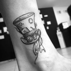 a black and white photo of a person's foot with a clock on it