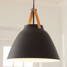 a black and orange light hanging from a ceiling