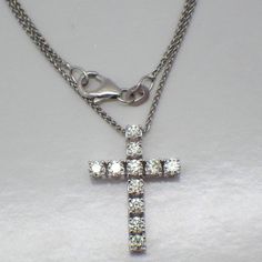 Vintage 14k (.585) white gold chain necklace with a cross pendant, decorated with Diamonds - approx. 0.7tcw, SI1-SI2 clarity, color J-K. This darling cross is 21 mm x 15 mm, the chain is 17 7/8" long and 1 mm wide, total weight is 3.7 grams. EA5027 White Diamond-cut Pendant Cross Necklace, White Diamond Cut Pendant Cross Necklace, White Gold Crucifix Necklace For Formal Occasions, White Gold Crucifix Necklace With Vvs Clarity, White Diamond Crucifix Necklace, White Crucifix Cross Necklace With Brilliant Cut, White Diamond Cross Necklace Fine Jewelry, Fine Jewelry White Diamond Cross Necklace, White Cross Diamond Necklace Fine Jewelry