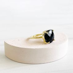 Classic and wearable, this stunning ring will definitely make a statement. Also available in other gemstones GEMSTONE: Onyx STONE SIZE: 12mm x 12mm RING SIZE: Adjustable MATERIAL: gold/silver plated brass Onyx Gemstone, Onyx Stone, Gems Jewelry, Gemstone Ring, Solitaire Ring, Black Onyx, Prong Setting, Silver Color, Statement Rings