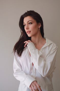 a woman in white shirt posing for the camera