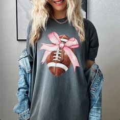 Step up your game day style with the Football Coquette Bow Comfort Colors Graphic Tee! This short sleeve tee combines a playful bow design with football flair, perfect for showing off your team spirit with a touch of chic. Made from ultra-soft Comfort Colors fabric, this tee ensures maximum comfort and a relaxed fit, making it an ideal choice for cheering from the stands or tailgating. Proudly made in the USA, it’s designed to be a standout piece in your game day wardrobe. Details:This listing i Beach Bachelorette Party Shirts, Floppy Beach Hat, Patriotic Tees, Bridesmaid Gifts Jewelry, Mama Tee, Christian Tees, Coquette Bow, Bachelorette Party Shirts, Jewelry Essentials