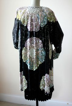 "Probably one of the most beautiful 2pc suit sets I have ever seen. The detail on this is amazing and it is simply fabulous in every way! First, I see no flaws. The coat is so stunning and it seriously drips pearls..as there are several that are attached to beads and look like fringe. There is almost a floral style look on the coat..with the most beautiful pastel colors. There is a hook at the top, but this coat alone could be used for your most special of occasions. Then there is the dress unde Elegant Costume Dress With Sequins, Glamorous Beaded Evening Outerwear, Festive Beaded Outerwear, Vintage Beaded Evening Outerwear, Black Sequin Hooded Kimono, Vintage Fitted Sequin Outerwear, Beaded Party Dress, Sequin Beading, Sequin Top