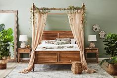 a bedroom with a canopy bed and lots of potted plants on the floor next to it