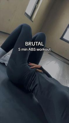 a woman is laying on the floor with her legs spread out and there is an ad that says brutal 5 min abs workout