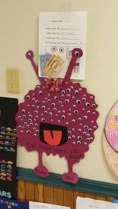 a bulletin board with an image of a pink sheep on it and some other decorations