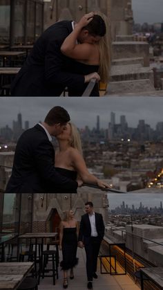 a man and woman kissing on top of a building