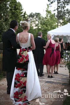 a man and woman in formal wear standing next to each other