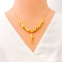 Weighing 10.2 grams, this 21k gold necklace showcases a decorative design with a radiant yellow gold finish, perfect for a dressy occasion. The 17-inch length provides a comfortable fit, while the 1.25-inch drop adds an elegant touch of sophistication. Secured with a lobster lock, this piece combines timeless beauty with intricate craftsmanship, making it an ideal accessory for special events or to elevate everyday style. PRODUCT DETAILS Gold Purity(karat): 21k Gold Weight(grams): 10.2 Item Fini Elegant Yellow Gold Plated Necklaces, Festive 22k Yellow Gold Necklace, Festive Yellow Gold Necklaces With Gold Beads, Festive Yellow Gold Plated Necklaces, Festive Yellow Gold Necklace With Gold Beads, Elegant Yellow Gold Temple Necklace With Gold Beads, Indian Rings, Bridal Jewelry Necklace, Precious Stones Rings