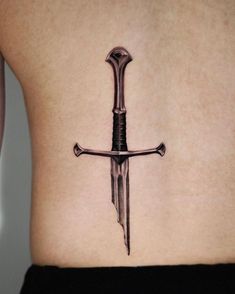 A sword tattoo is one of the most iconic designs. But only a few people know the true meaning behind it. Dive into our research to become a real sword tattoo lord. Alpha Male Tattoo, Blue Ribbon Tattoo, October Tattoos, Fine Tattoos, Seoul Hongdae, Lotr Tattoo, Lord Of The Rings Tattoo, Shamrock Tattoos, Inner Bicep Tattoo