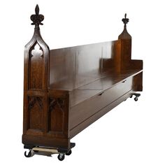 an old wooden bed with wheels on the bottom and side rails that are attached to each other