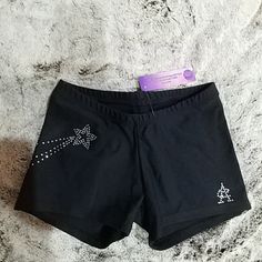 a pair of black shorts with bows on the side and sequins on the back