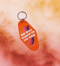 an orange keychain with the words no beard vibes in his gnar on it