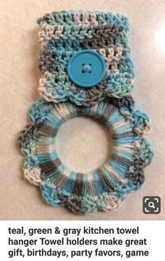 two crocheted hair ties with a blue button on top of each one in the shape of a flower