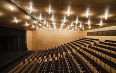 an empty auditorium with rows of seats and lights