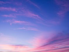 the sky is pink and blue at sunset