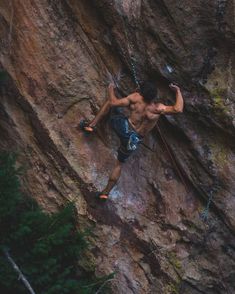 a man climbing up the side of a mountain