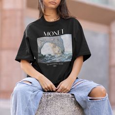 This oversized Monet Art History Lovers T-shirt is unisex for men or women! Perfect tee for everyday use and is high quality 100% cotton. Very soft with a vintage feel.  Color: Black Available in S-3XL. We recommend sizing 1-2 sizes up for the oversized look, or if you like a more fitted style you can order your normal t-shirt size.  (Model is normally a size small t-shirt and is wearing a size Large in this tee)  featured Artwork: Manneporte by Claude Monet Material: 100% Ring-spun Cotton. Colo Artistic Oversized Graphic Print T-shirt, Artistic Oversized T-shirt For Streetwear, Aesthetic Relaxed Fit T-shirt For Streetwear, Oversized Artistic Cotton T-shirt, Artistic Oversized Cotton T-shirt, Artistic Oversized Graphic Tops, Artistic Oversized T-shirt With Graphic Print, Oversized Artistic Graphic Print T-shirt, Artistic Oversized Tops With Letter Print