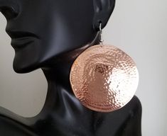 Solid copper hammered disc earrings. The hammering domes them slightly. They are on sterling ear wires and available in 7 sizes, The small ones are 5/8ths of an inch in diameter, the medium are 1 inch in diameter, the large are 1&1/2 inches in diameter, the extra large are 2 inches in diameter, the XXlarge are 2&1/2 inches in diameter, the 3X are 3 inches in diameter, and the 4X are 3&1/2 inches in diameter. One earring of the large size weighs 6 grams, and one of the extra large wei Adjustable Hammered Circle Earrings, Rose Gold Hammered Metal Earrings, Hammered Rose Gold Copper Earrings, Hammered Copper Round Hoop Earrings, Round Electroformed Metal Earrings, Electroformed Round Metal Earrings, One Earring, Hammered Earrings, Disc Earrings