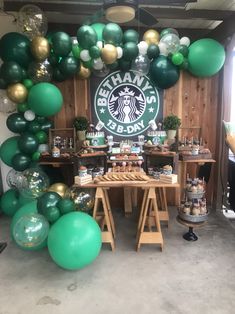 a starbucks coffee themed birthday party with green and gold balloon garlands, balloons, and decorations