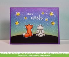 a handmade card with an image of a fox and a dog on the grass