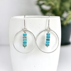 Add some bohemian vibes to your look with our handmade Boho silver hoop earrings. These sterling silver hoops feature a unique turquoise jasper gemstone dangle, adding a pop of color to your style. Perfect for a free-spirited and playful look, or make it a great gift! * .925 Sterling Silver * Measure approximately 1.125" in diameter  * Earrings Hang 1.75" from top of ear wire * Turquoise Jasper Gemstones * Polished to a high shine * Sent in a Gift Box with Polishing Cloth * Handmade in Montana ----- OUR MATERIALS -----  *STERLING SILVER - Experience the elegance of Sterling Silver, a metal that combines versatility with a sophisticated look. This durable and lightweight alloy is perfect for everyday wear, offering a timeless appeal. Our jewelry is crafted from .925 certified sterling silve Bohemian Vibes, Free Spirited, Handmade Boho, Sterling Silver Hoops, Precious Jewelry, Jasper Gemstone, Jewelry Earrings Hoops, Silver Hoops, Silver Hoop Earrings