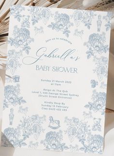 a blue and white baby shower with flowers on it