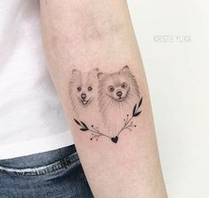 two bears on the arm with arrows and leaves around them, one is black and white