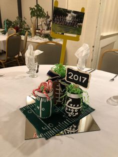 a football themed centerpiece sits on top of a table at a sports banquet or graduation party